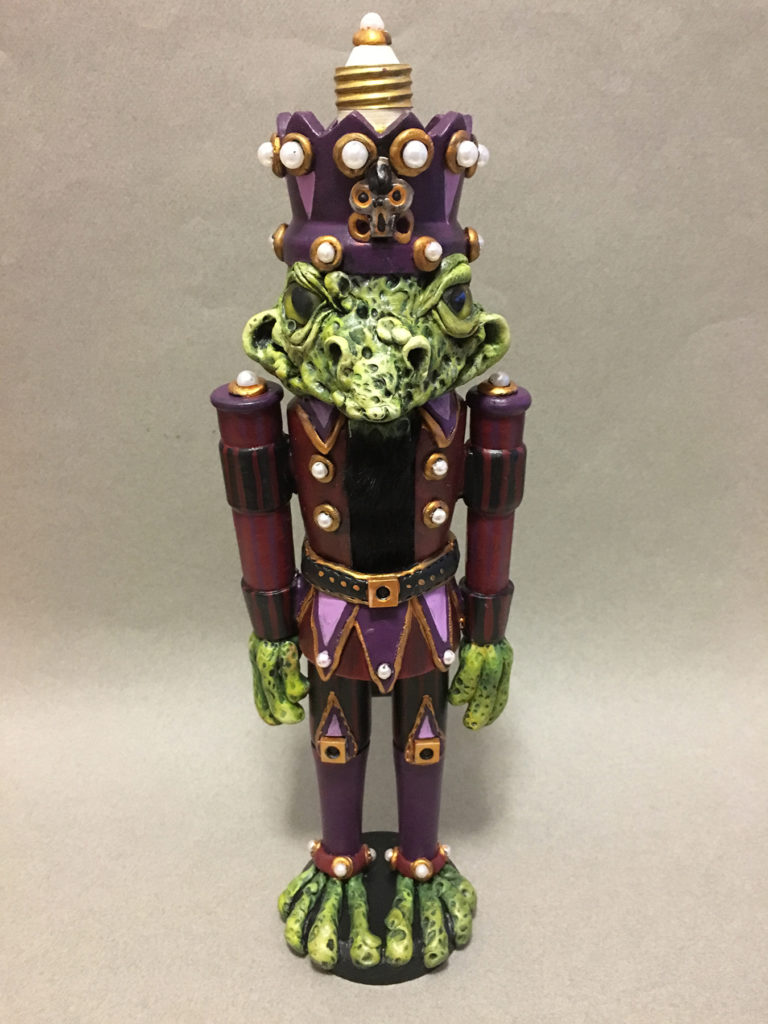 </br><p align="left"><strong><em>Sir Frog Nutcracker</em></strong></br>14.5" tall</br>Mixed media</br>$190</br><strong><a href="https://checkout.square.site/buy/MAKJFLK6VZQ26COEYG72YIWV">PURCHASE</a></strong></p><br>
